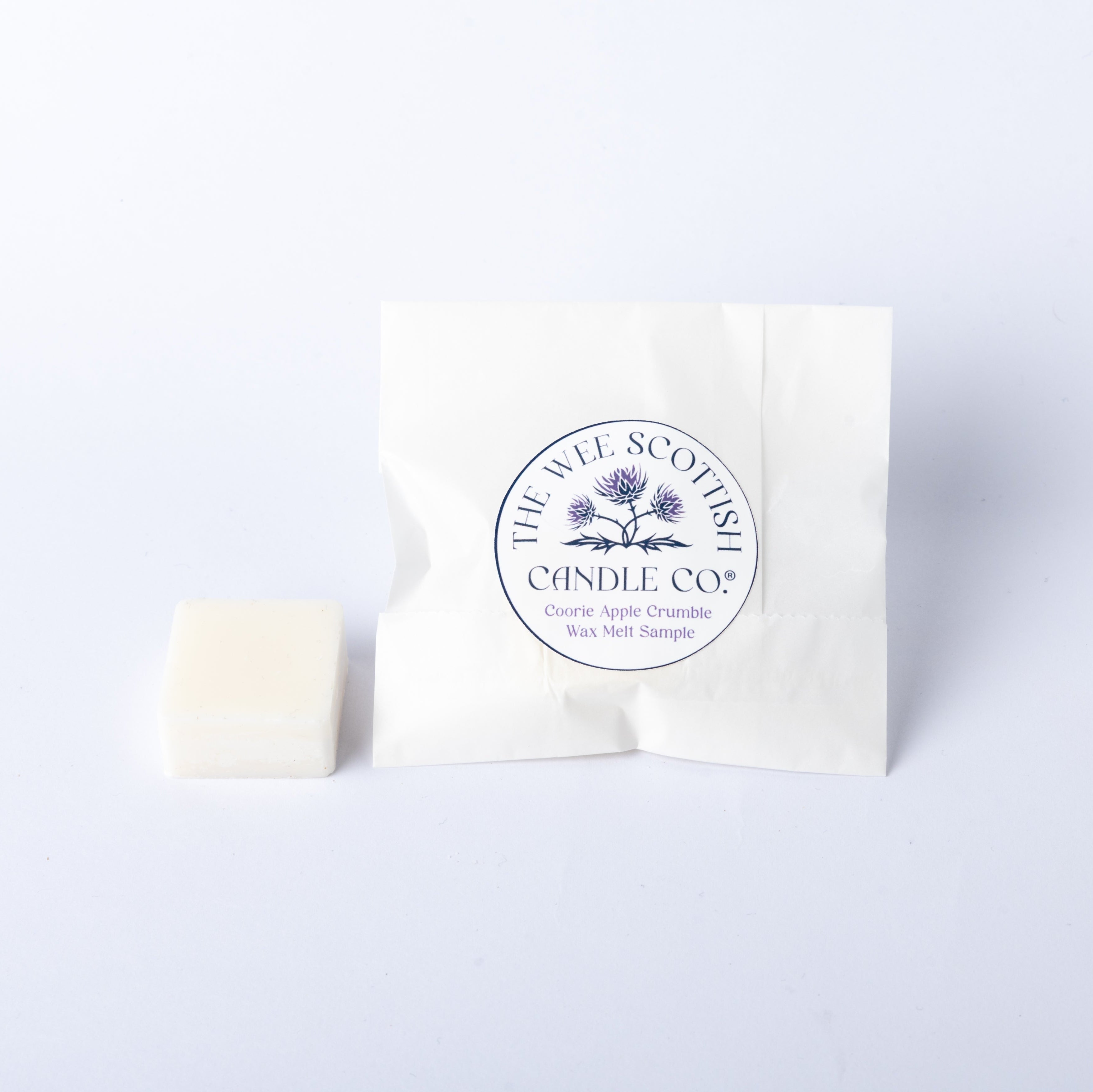White wax melt and packaging with 'The Wee Scottish Candle Co.' logo on a light grey background