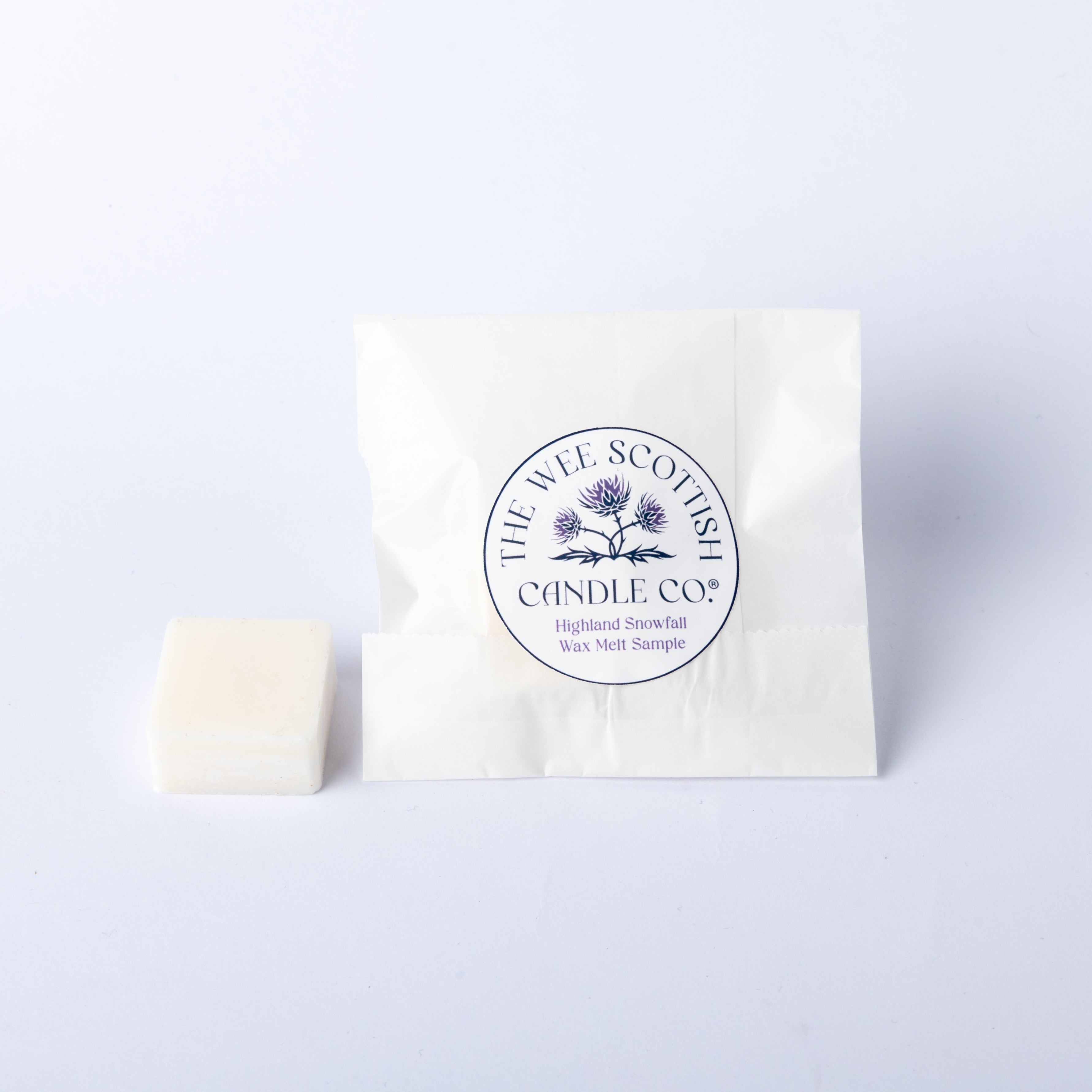 White wax melt and packaging with 'The Wee Scottish Candle Co.' logo on a light grey background